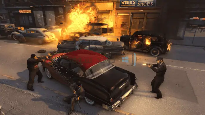 فن الغلاف للعبة Mafia 2 2025 يظهر مشهدًا حضريًا قاسيًا مع سيارة قديمة وشخصية غامضة ترتدي قبعة فيدورا.